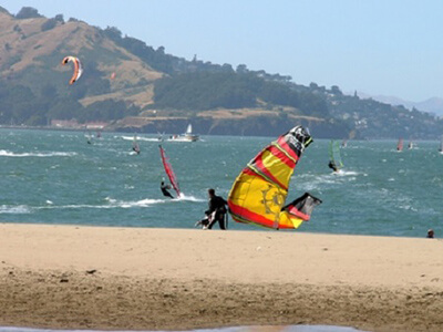 Many kiteboarders on the water