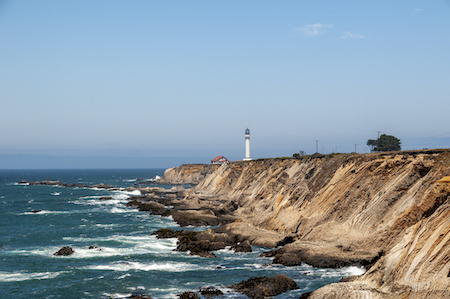 A shot of a lighthouse from afar by the shore